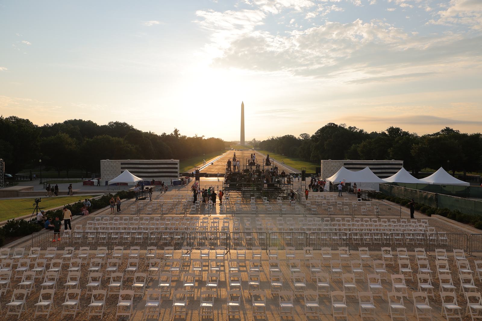 Sunrise over the National Mall with chairs set in rows and event tents in place.