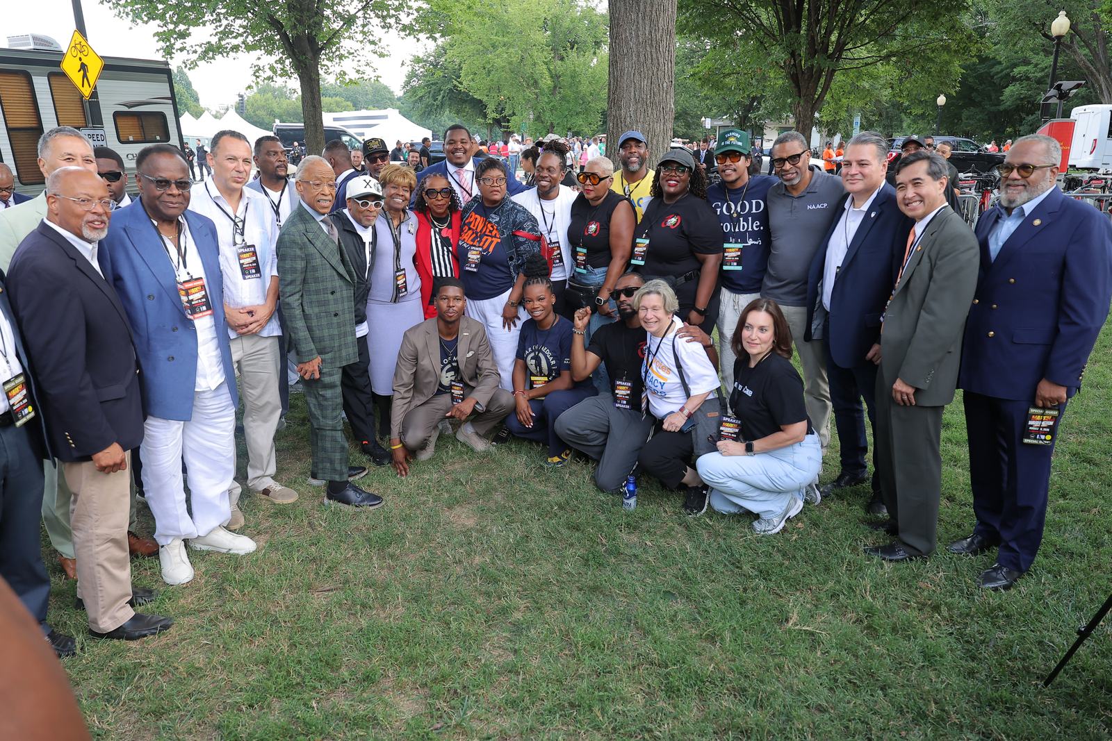 A large group of partner organization leaders and staff posed together at the march.