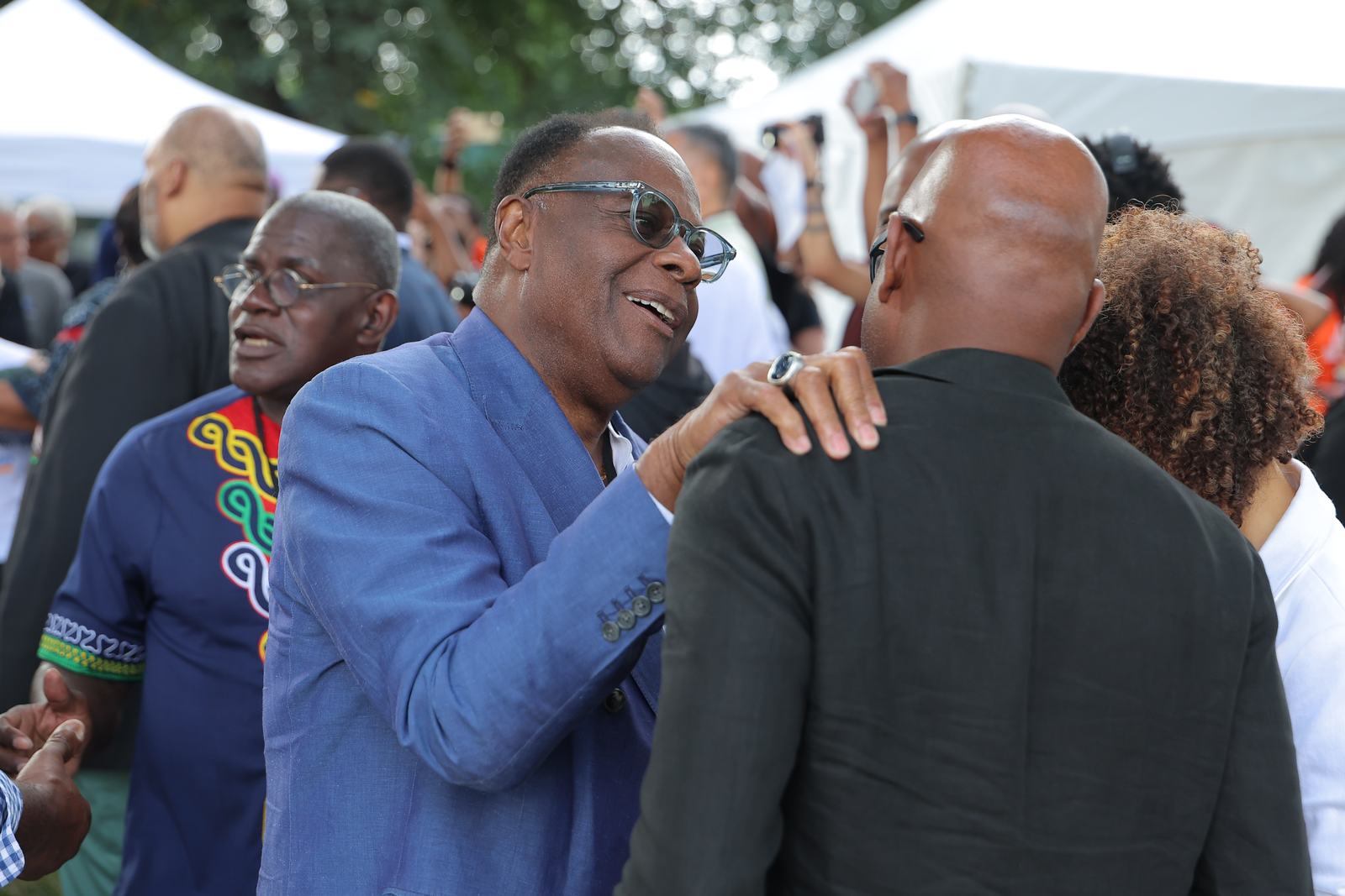 Leaders greeting one another warmly among the crowd at the March on Washington 2026.